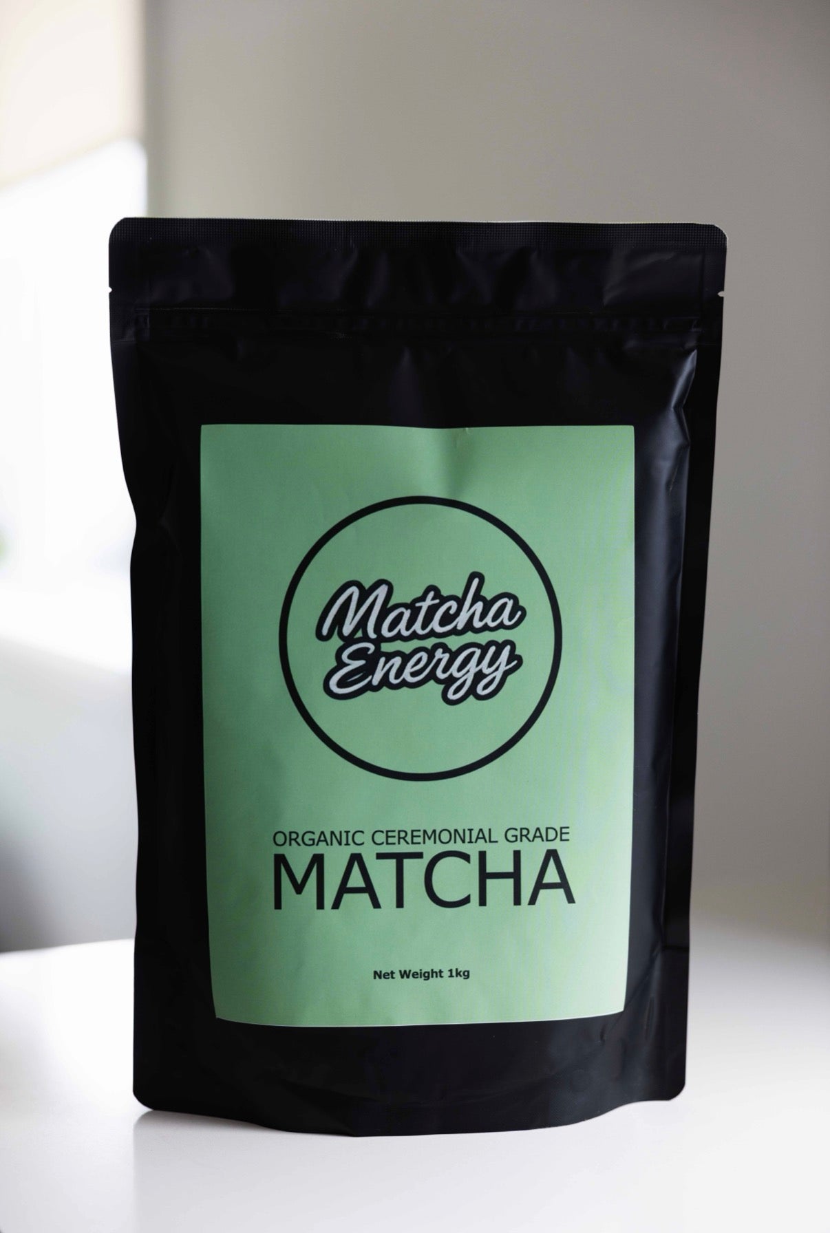 Matcha Energy matcha green tea package on a white surface with a light gray background